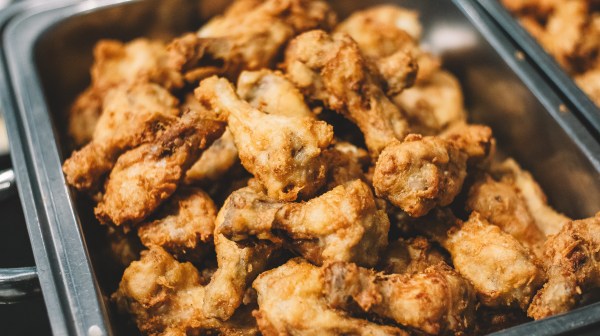 Tray filled with golden-brown fried chicken wings.